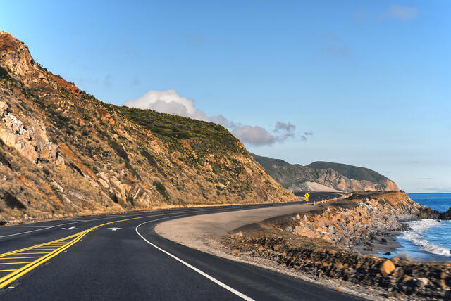 Close up of a mountain and road on a California coast road trip.