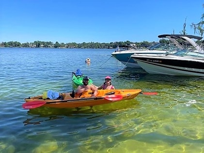 Hilton Grand Vacations Explorers posing with kayaks in Butler Chain of Lakes, Central Florida. 