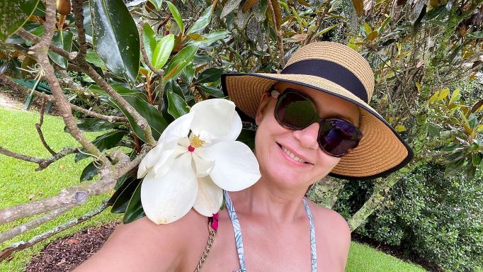 Hilton Grand Vacations Owner posing magnolia flower in selfie on Myrtle Beach vacation, South Carolina.
