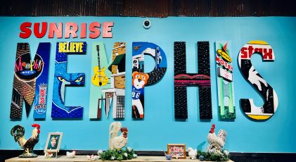 Art piece of big block letters that read "Memphis," and in each letter is an aspect of Memphis, including Beale Street and the Memphis Grizzlies basketball team